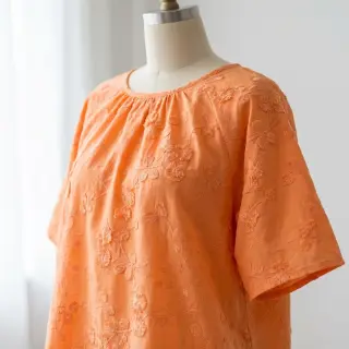 Cotton fabric EMBROIDERY Catchy leaves orange