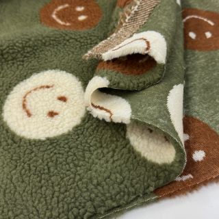 Coat fabric TEDDY JACQUARD Happy faces green